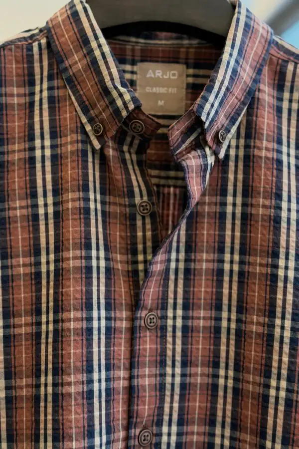 Blending Rust Brown, Navy Blue, And Off-White In A Perfectly Balanced Plaid Shirt